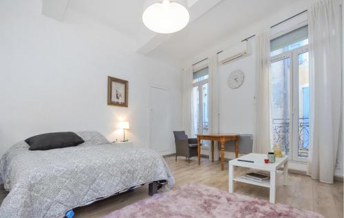 a bedroom with a bed and a table and a desk at Nice Apartment In Barjols With Wifi in Barjols