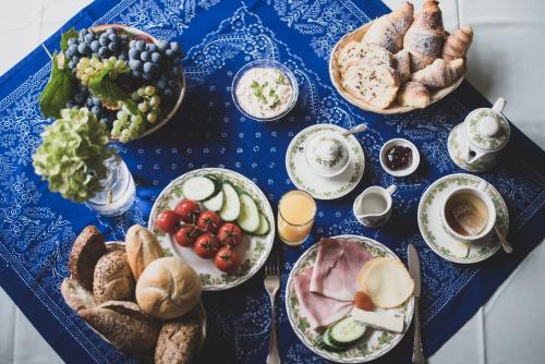 a blue table topped with lots of different types of food at Öreg Prés Butikhotel in Mór