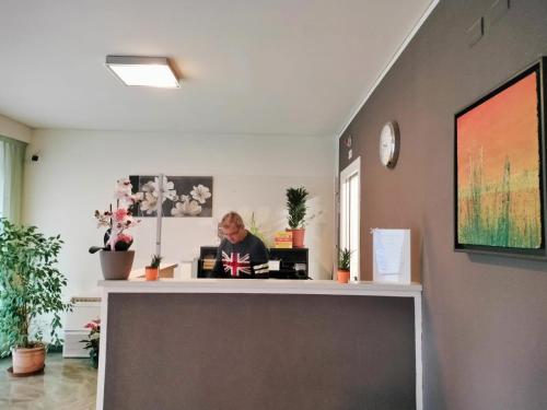 a person sitting at a desk in an office at Residence Igea in Rimini