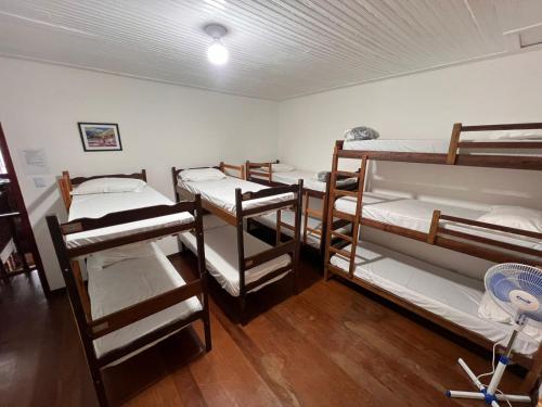 a group of bunk beds in a room at Pertin da Praça Hostel in Ouro Preto