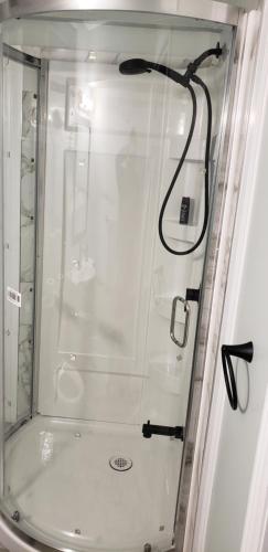 a shower with a glass door in a bathroom at 2 Bedroom Luxury Apartment in Guelph