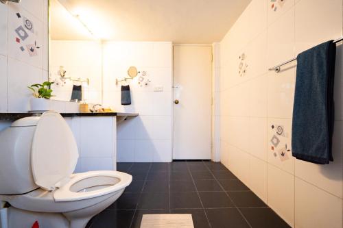 a bathroom with a toilet and a shower at Luho 306 in Bangalore