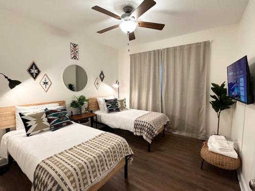 1 dormitorio con 2 camas y ventilador de techo en The Prairie Suite Newly Built Upscale Central, en Gainesville