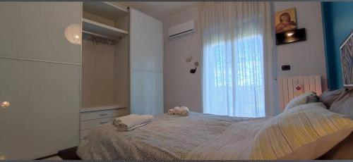 a bedroom with a bed and a window at Sweet house in Bari