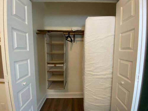 a room with a closet with a roll of toilet paper at The Floridian Newly Built Dreamhome Central in Gainesville