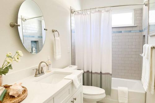 a bathroom with a sink and a toilet and a mirror at The Floridian Newly Built Dreamhome Central in Gainesville