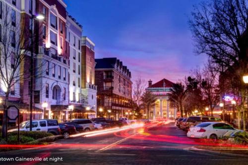 a city street at night with cars parked at The Floridian Newly Built Dreamhome Central in Gainesville