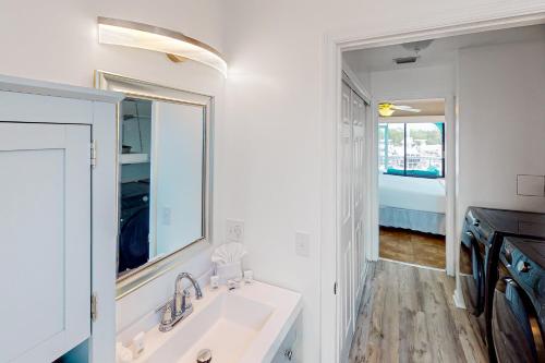 uma casa de banho branca com um lavatório e um espelho em Endless Summerland em Summerland Key