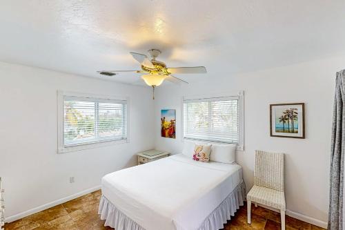 a bedroom with a white bed and a ceiling fan at Endless Summerland in Summerland Key