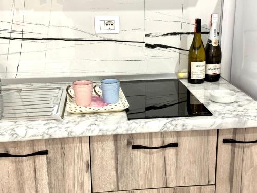 a kitchen with a counter with two bottles of wine at Shell Home golem 1 in Golem