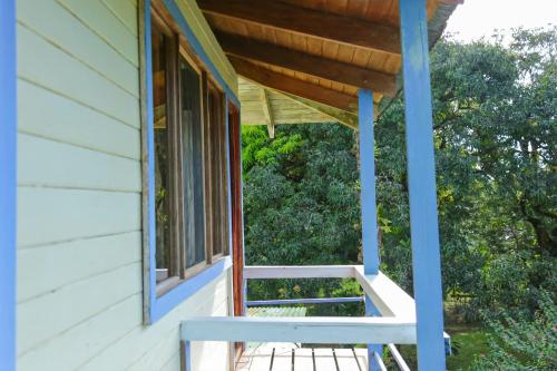 a porch of a house with a window and a bench at Casa Drake Lodge in Drake