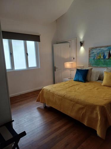 a bedroom with a large bed and a window at Explora Prestige in Blue Bay