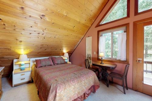 una camera con letto, scrivania e finestre di Rustic Lausanne a Truckee