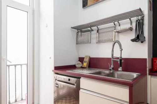 a kitchen with a sink and a counter top at Pombalino Design Apartment em BaixaChiado in Lisbon