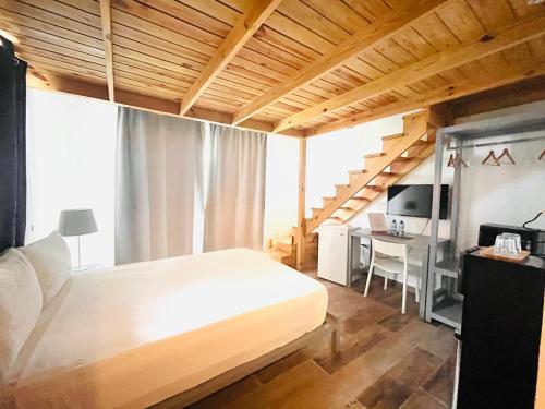 ein Schlafzimmer mit einem Bett, einem Schreibtisch und einer Treppe in der Unterkunft Paraíso Bayahibe in Bayahibe