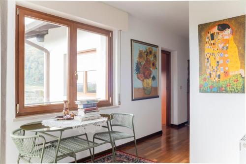 a room with a table and chairs and a window at Torlanoholidayhome it - 4 bedrooms home in the countryside - sauna, wine, swim in the creek in Nimis