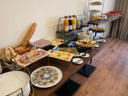 a table with many plates of food on it at The Home Boutique Hotel Pyramids Inn in Cairo