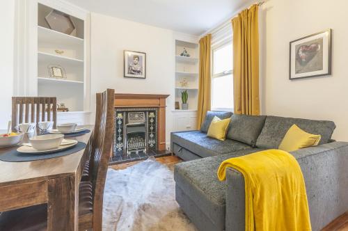 a living room with a couch and a table at Bovey House, single or king beds. Central in Exeter