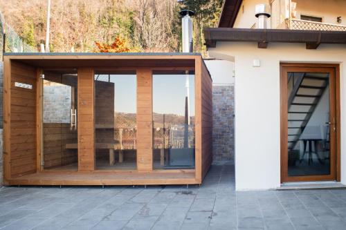 a glass extension to a house with a patio at Torlanoholidayhome it - 4 bedrooms home in the countryside - sauna, wine, swim in the creek in Nimis