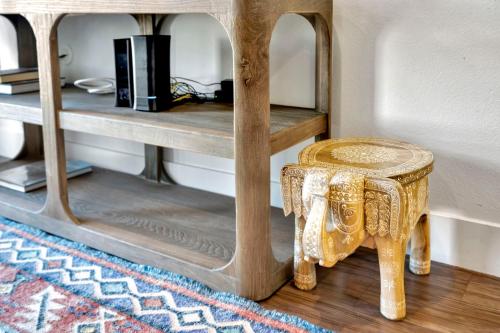 a stool sitting next to a shelf with a table at 13 Luxury apartment in Los Angeles