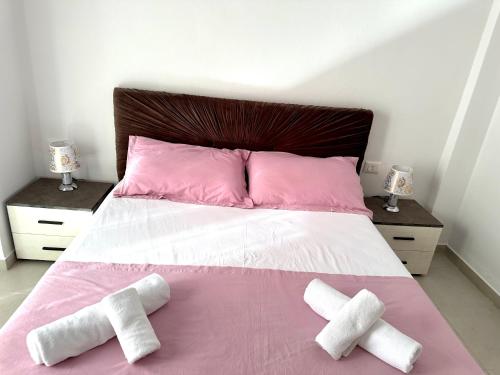 a bedroom with a bed with two towels on it at Shell Home golem 1 in Golem