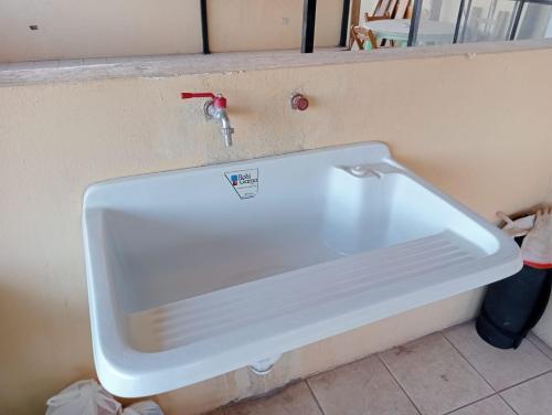 a white sink with a faucet in a bathroom at Posada de Mama in Cusco