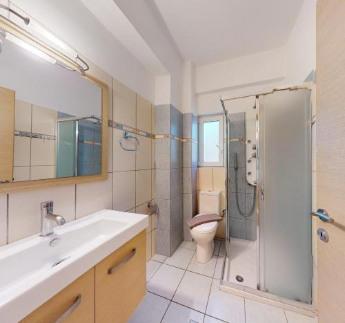 a bathroom with a shower and a sink and a toilet at Mediterraneo Resort in Parga