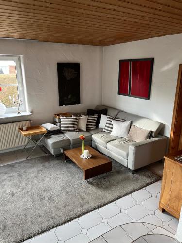 a living room with a couch and a table at Superschöne Ferienwohnungen! in Buxheim