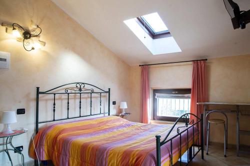 a bedroom with a bed and a skylight at Agriturismo Gaspari Farm in Volta Mantovana