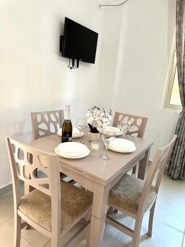 a dining room table with chairs and a bottle of wine at Shell Home golem 1 in Golem