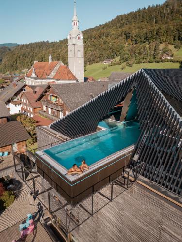 two people in a swimming pool on top of a building at GAMS zu zweit in Bezau