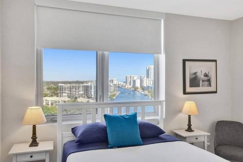 a bedroom with a bed and a large window at Perfect Vacation Large Condo Breathtaking Views in Hallandale Beach
