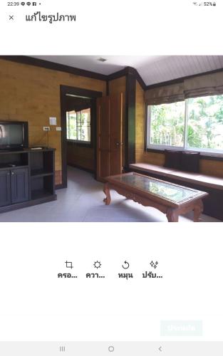 a living room with a bench and a tv at Wilai Villa Lamai in Lamai