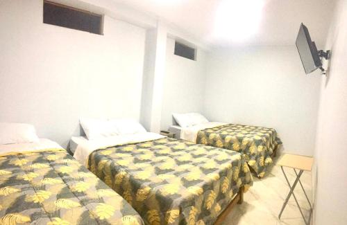 a room with two beds in a room at Áncora Beach Hotel in Máncora