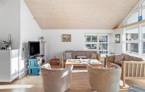 a living room with a couch and a table at 3 Bedroom Gorgeous Home In Dannemare in Dannemare
