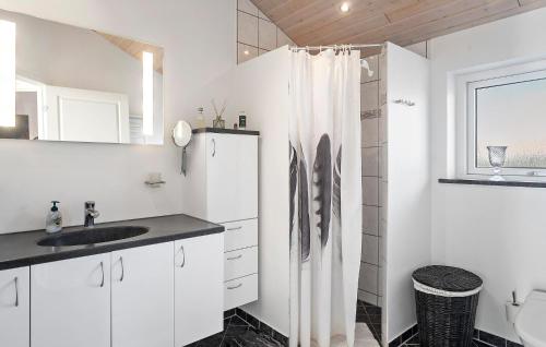 a white bathroom with a sink and a shower curtain at Stunning Home In Dannemare With Kitchen in Dannemare