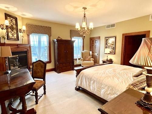 a bedroom with a bed and a desk and a piano at The Port Hotel in Port Washington