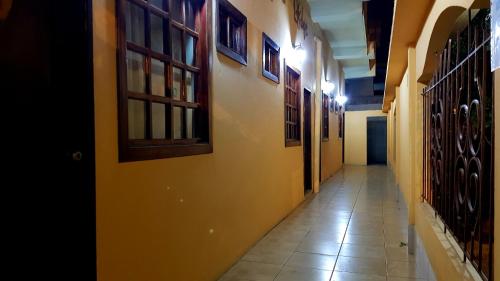 a hallway with yellow walls and a tile floor at Riveri Salinas BY CHAQANA in Salinas