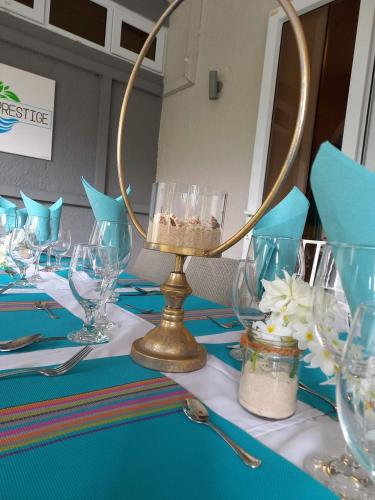 a table with a blue table with glasses on it at Explora Prestige in Blue Bay