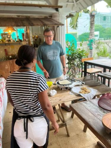 a man and a woman preparing food at a picnic table at Explora Prestige in Blue Bay