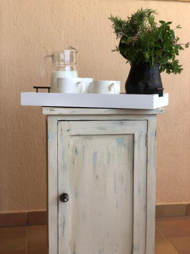 a white table with a plant on top of it at Penelope Dream Pool Villa in Minia