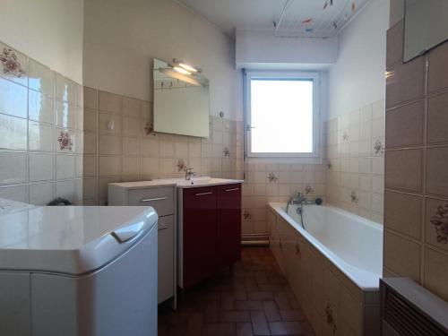 La salle de bains est pourvue d'une baignoire, d'un lavabo et d'une baignoire. dans l'établissement Résidence Saint Christophe - Logement traversant, agréable et lumineux à 2 pas de la cure ! MAE-7244, à Aix-les-Bains
