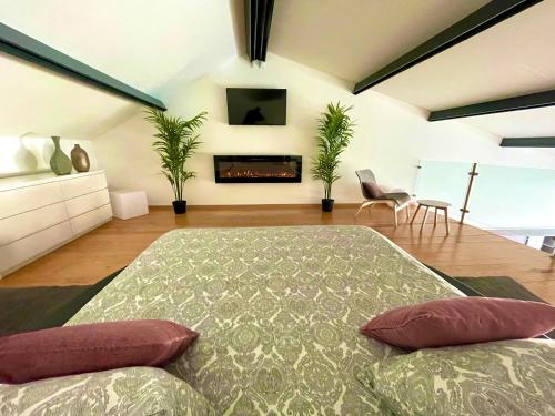 a living room with a bed and a fireplace at Janota Week with pool in Setúbal