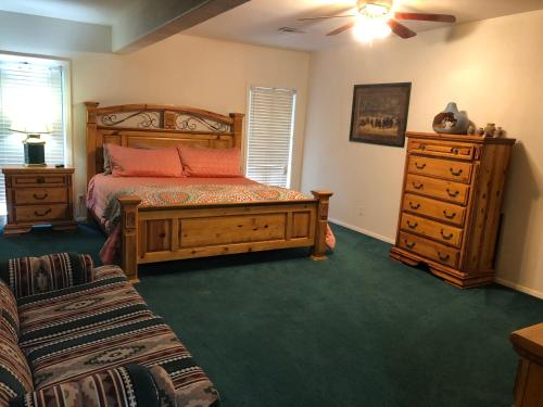 a bedroom with a bed and a dresser at River Hideout: One Bedroom Duplex Cottage ON THE RIVER!! in Ruidoso