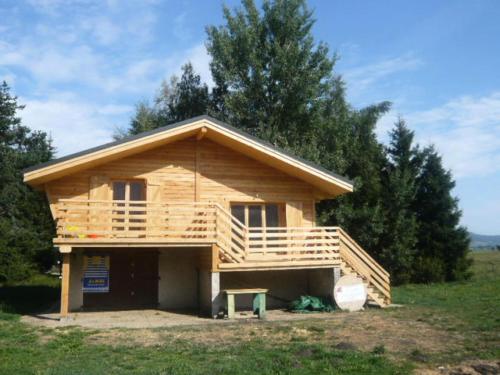 a log cabin in a field with trees at Chalet - Chalets 494 in Lans-en-Vercors