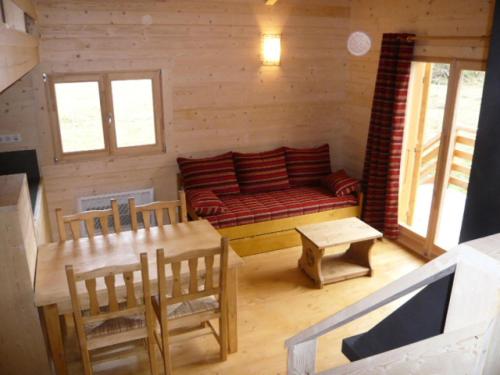 a living room with a couch and a table and chairs at Chalet - Chalets 494 in Lans-en-Vercors