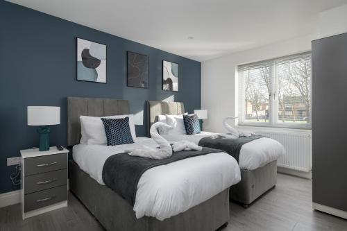 4bed perfect for contractors & Long Stays By Valore Property Services tesisinde bir odada yatak veya yataklar