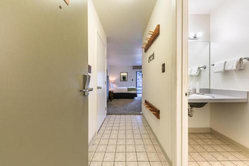 a hallway leading into a hotel room with a bathroom at Quiant Studio w/Lake View #144 at Donner Lake Village in Truckee