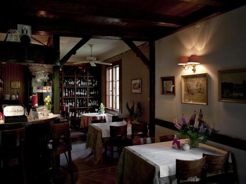 a dining room with two tables and a bar at Leśny Dworek in Wyszk&oacute;w