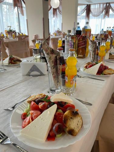 a table with a plate of food on a table at Хотел Ботевград in Botevgrad
